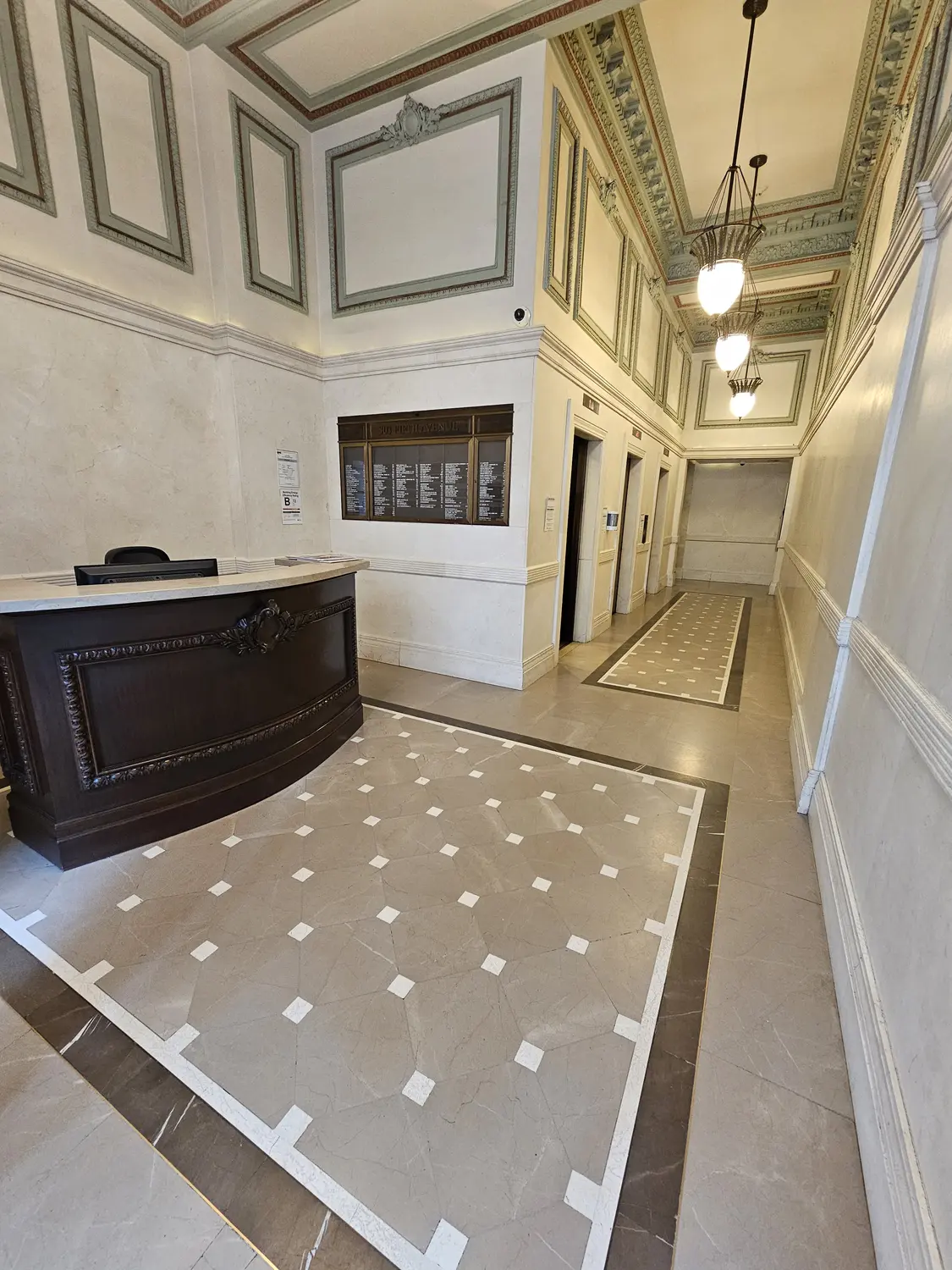The attended lobby and elevator bank at 303 Fifth Avenue